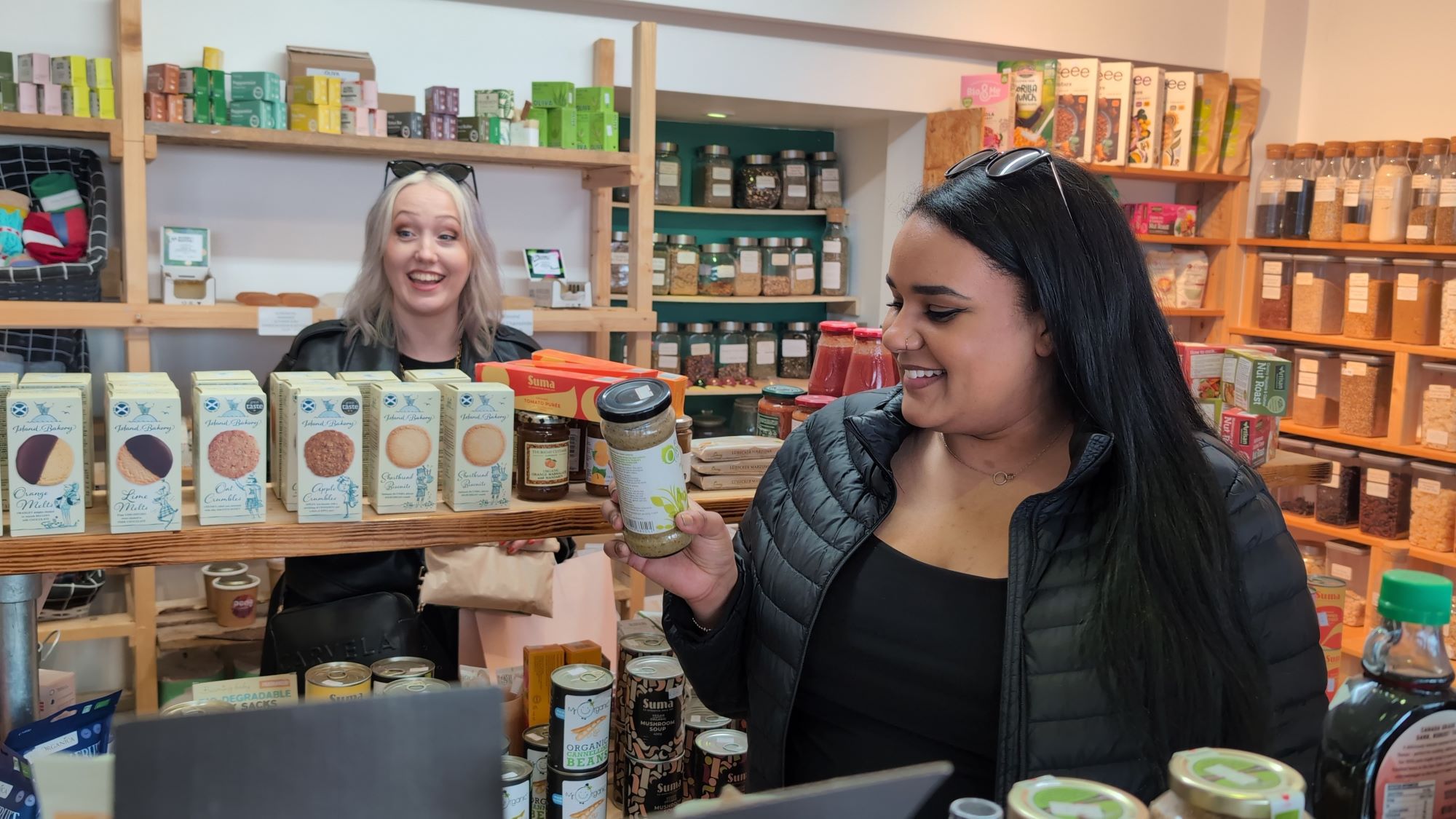 Two shoppers looking at eco-friendly products